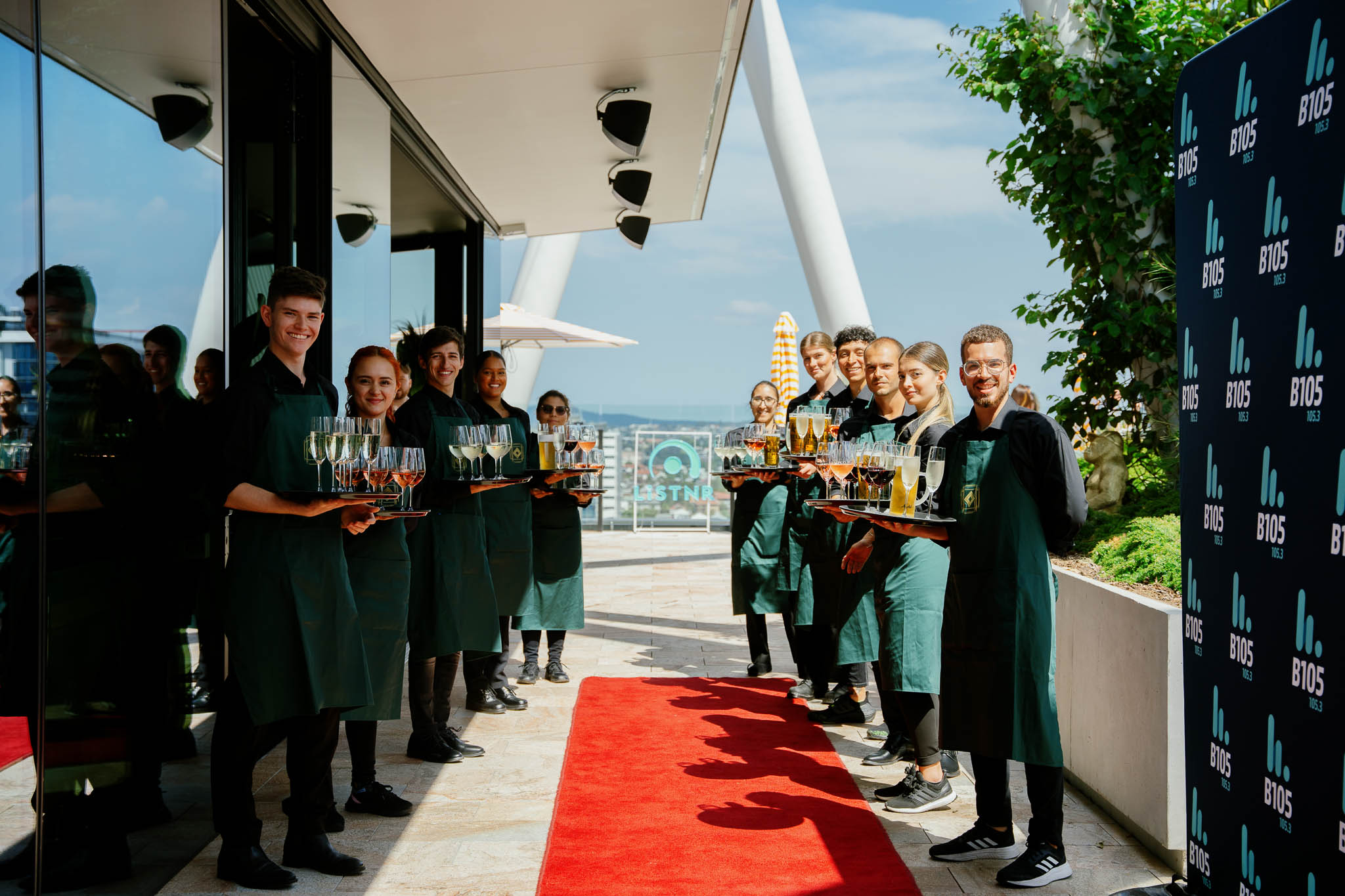 rooftop function, waiters holding drinks on arrival